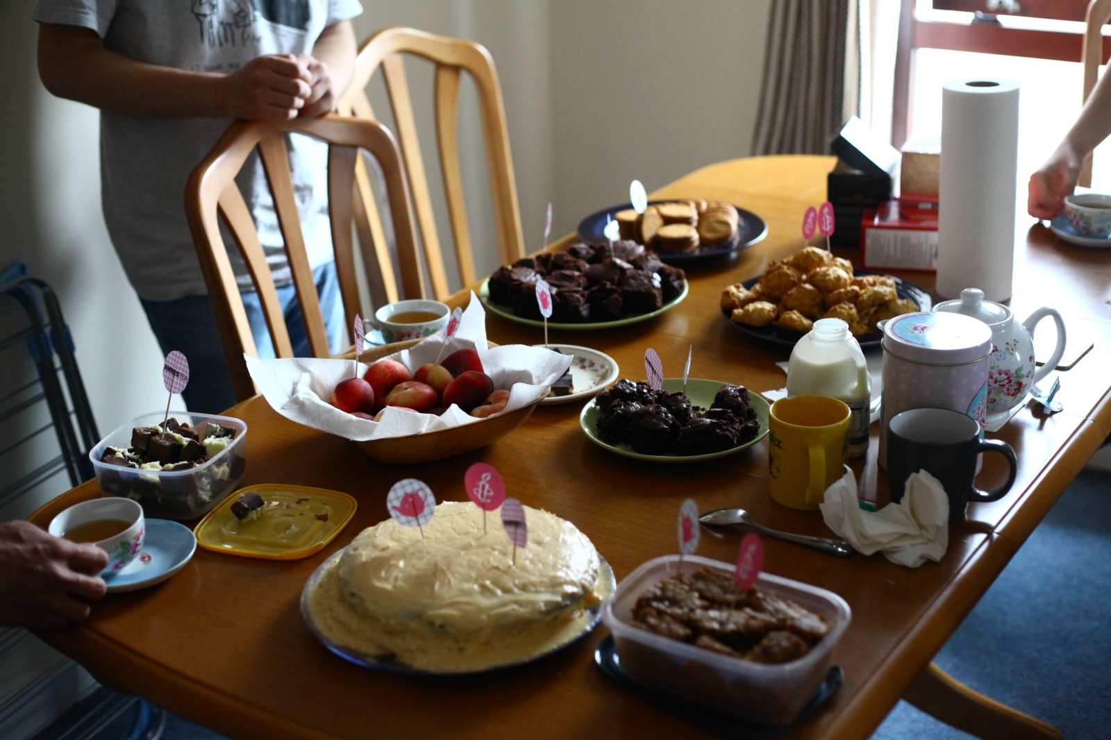 A table *full* of cakes biscuits sweets and tea!